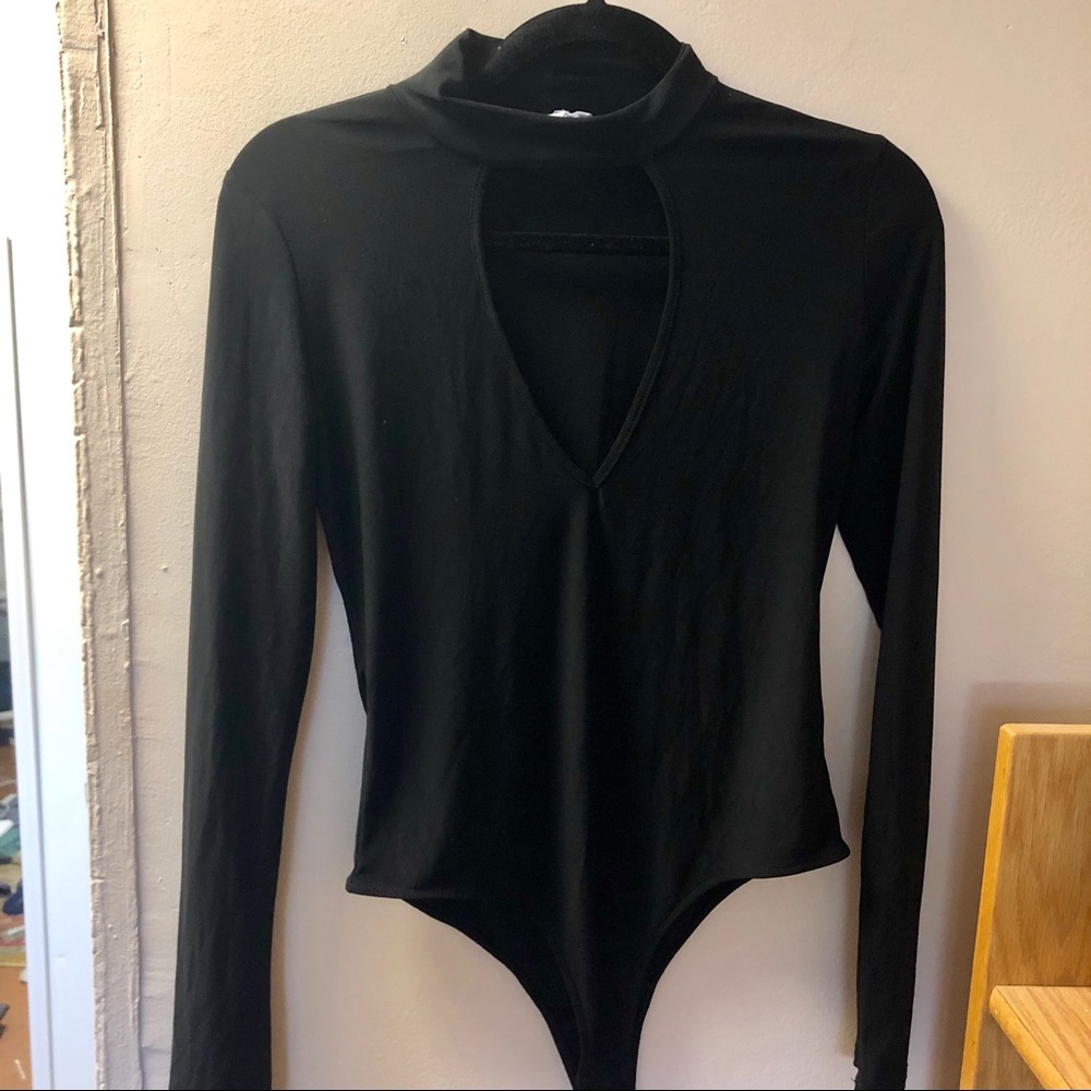 Black turtleneck bodysuit with chest open.
